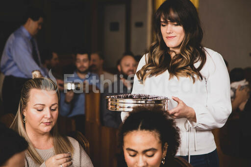 Woman Passing Out Communion