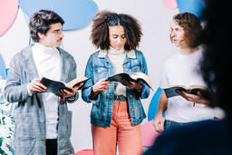 Young People Reading their Bibles Together and Discussing  image 1