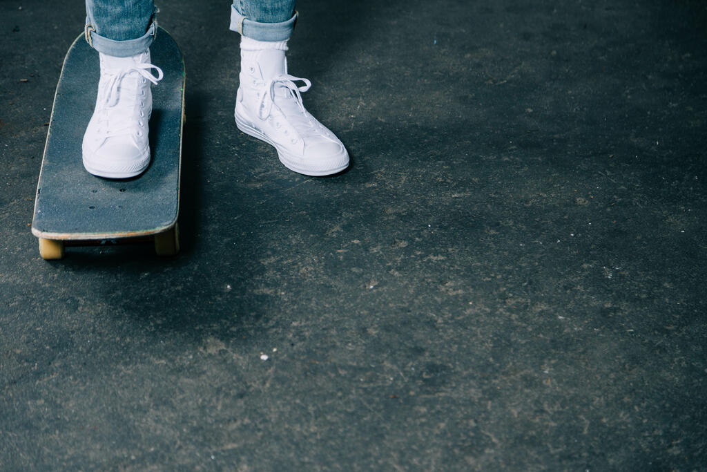 Person in White Tennis Shoes Getting on a Skateboard large preview