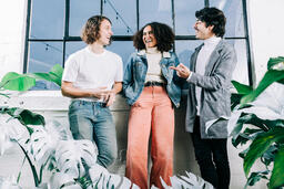 Young People Laughing and Standing Amongst Plants  image 1