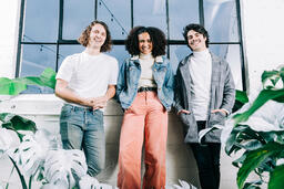 Young People Laughing and Standing Amongst Plants  image 2