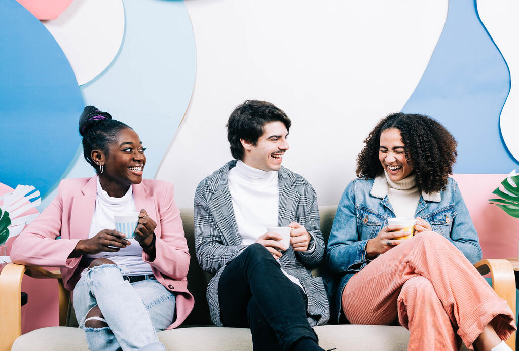 Young People Drinking Coffee and Laughing Together large preview