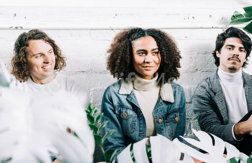Young People Sitting Together Amongst Plants