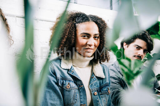Young People Sitting Amongst Plants
