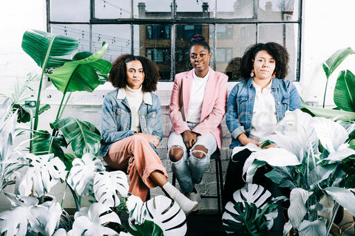 Women Sitting Together Surrounded by Plants