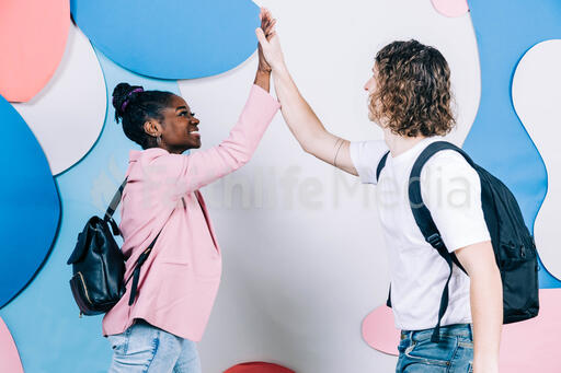 Young People High-Fiving Each Other