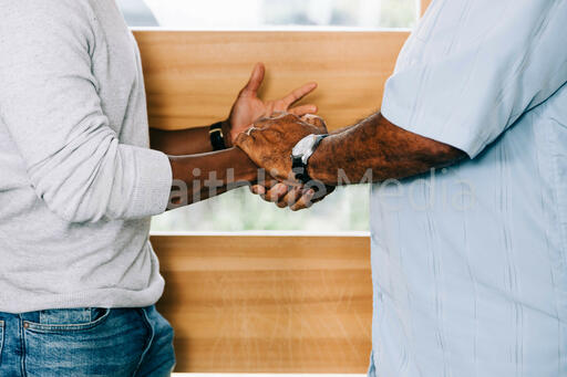 Men Shaking Hands at Entrance of Home