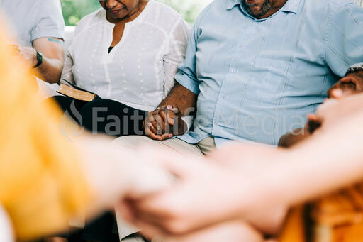 Small Group Members Holding Hands in Prayer
