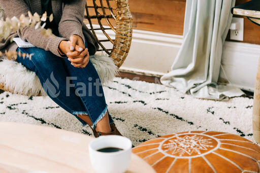 Woman Praying in Living Room