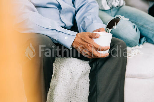 Small Group Member Holding a Cup of Coffee