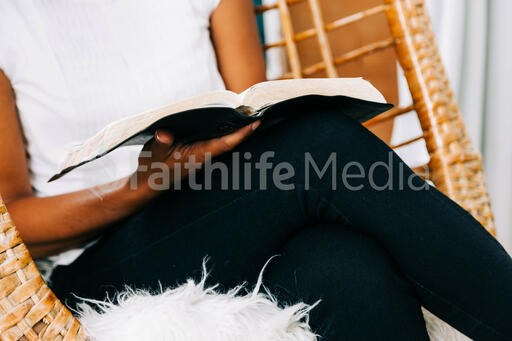 Woman Reading Open Bible on her Lap