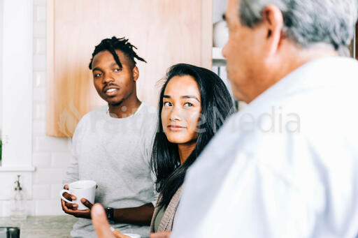 Small Group Members having Conversation in the Kitchen with Coffee