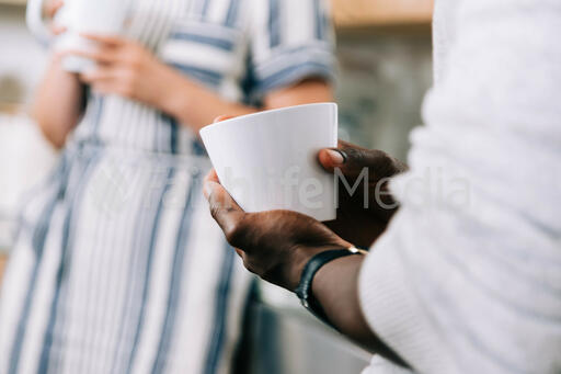People having Conversation in the Kitchen with Coffee