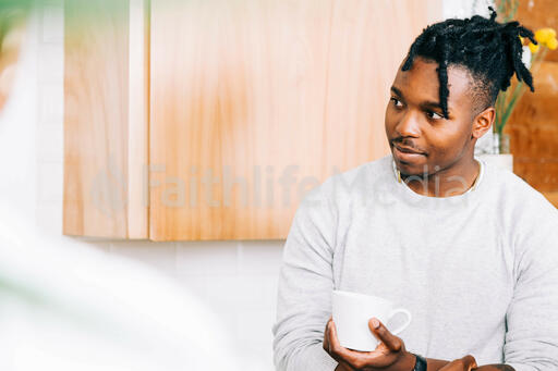 Man Holding Cup of Coffee and Having Conversation in the Kitchen