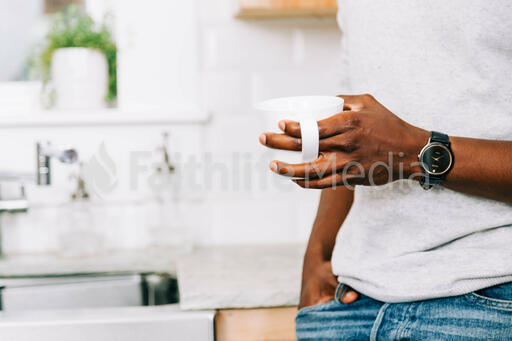 Man Holding Cup of Coffee in the Kitchen