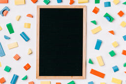 Blank Letter Board Surrounded by Colorful Wooden Blocks  image 1