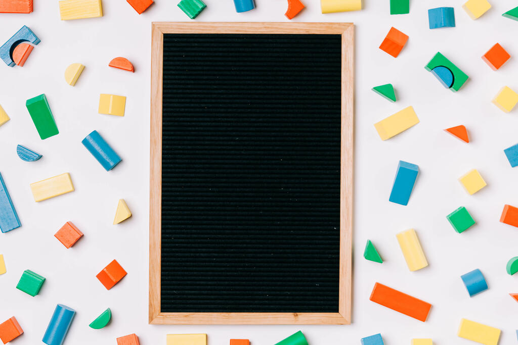 Blank Letter Board Surrounded by Colorful Wooden Blocks large preview