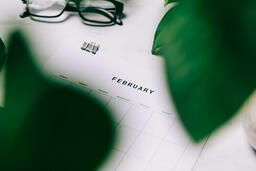Printed Calendar Behind Greenery  image 30