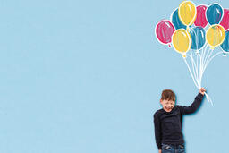 Boy Holding Illustrated Balloons  image 1
