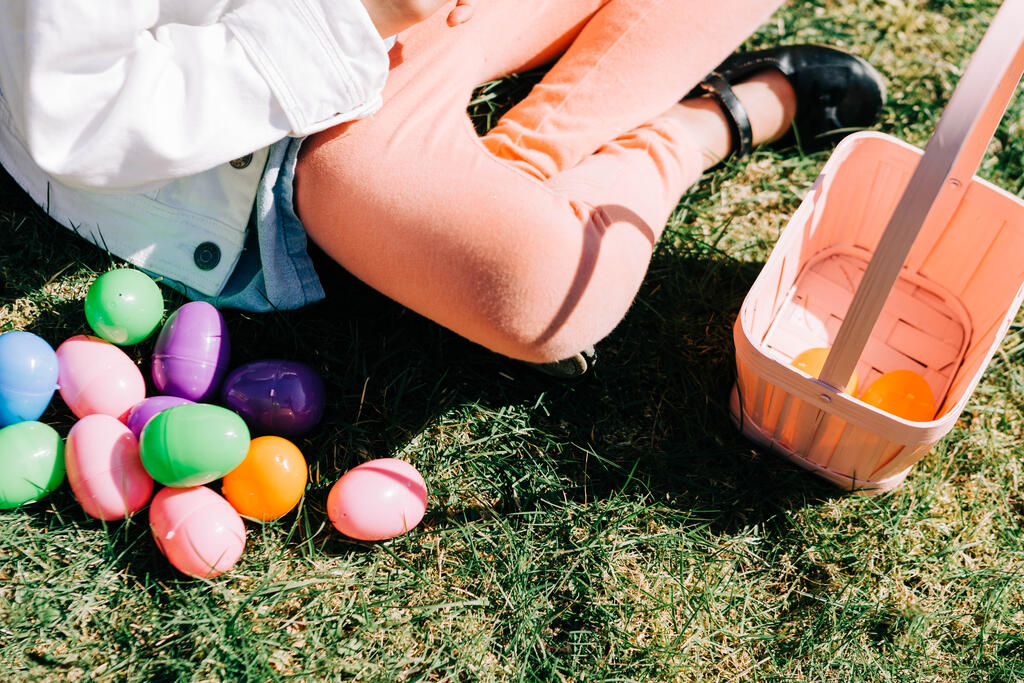 Child Looking Through Their Easter Eggs large preview