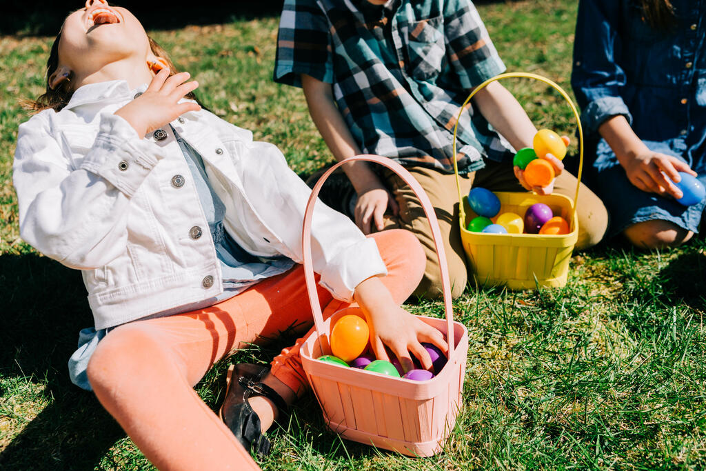 Kids Laughing and Looking Through Their Easter Eggs Together large preview