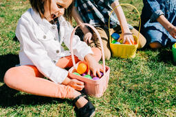 Kids Laughing and Looking Through Their Easter Eggs Together  image 2