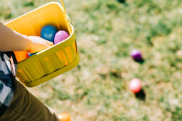 Child Putting an Egg in Their Easter Basket  image 2