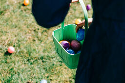 Child Putting an Egg in Their Easter Basket  image 3