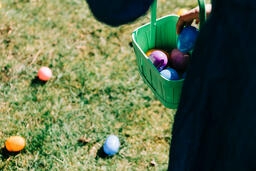 Child Putting an Egg in Their Easter Basket  image 2