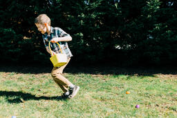 Boy Running in an Easter Egg hunt  image 1