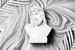 Christ Statue with Palm Leaves on Marbled Background  image 1