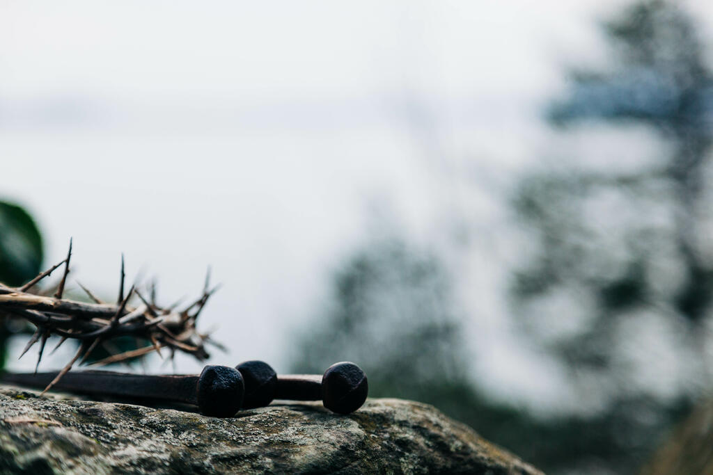 The Crown of Thorns and Crucifixion Nails on a Rock in Nature large preview