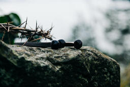 The Crown of Thorns and Crucifixion Nails on a Rock in Nature  image 3