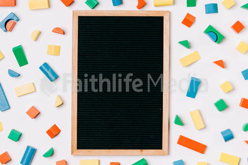 Blank Letter Board Surrounded by Colorful Wooden Blocks