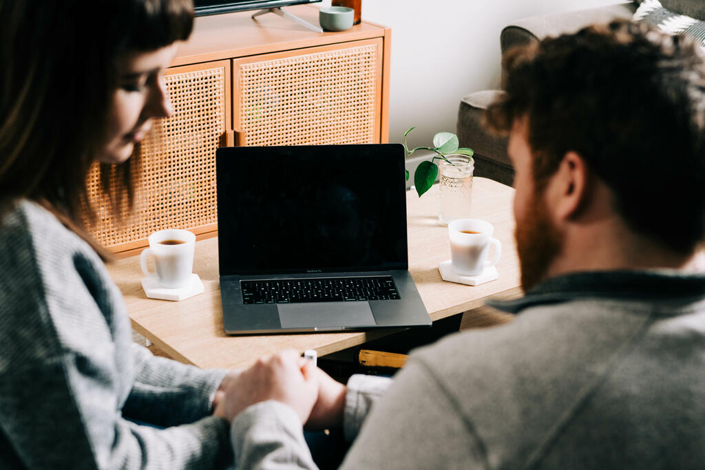 Couple Praying Together During Church at Home on a Laptop large preview