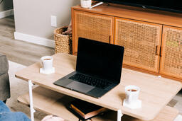 Laptop and Mugs on a Coffee Table  image 1