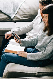 Couple Looking at a Smart Phone with an Open Bible  image 4