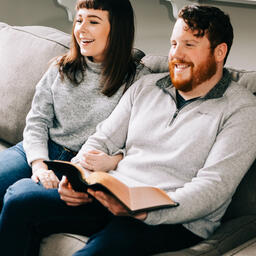 Couple Watching Church at Home with a Bible  image 2