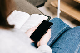 Woman Holding Her Phone and a Bible  image 2