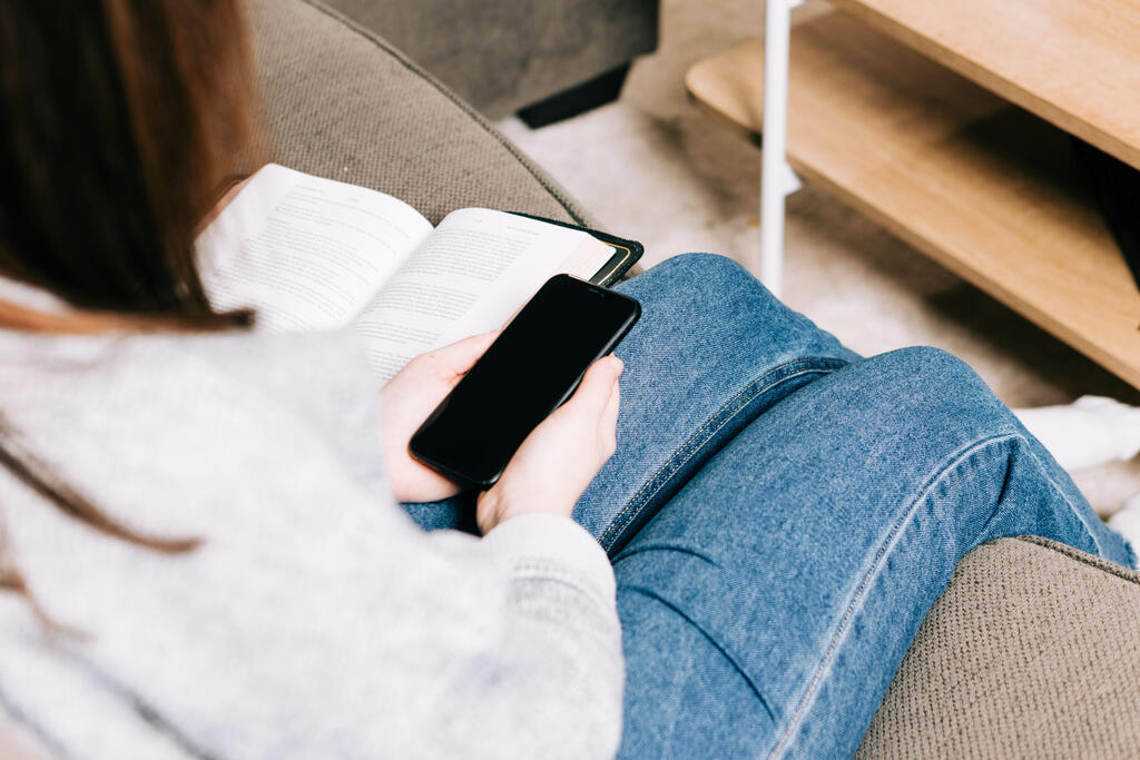 Woman Holding Her Phone and a Bible large preview