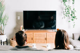 Couple Watching Church at Home on a TV  image 1