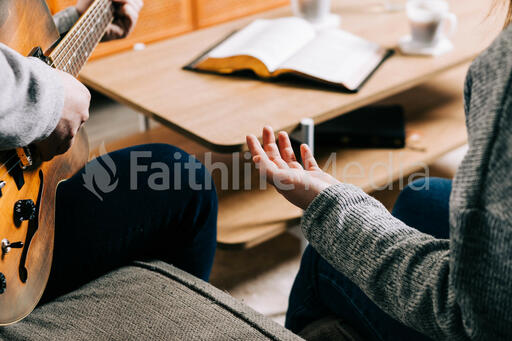 Couple Worshipping Together at Home