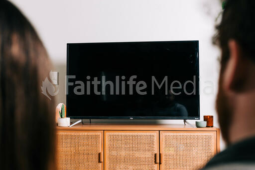 Couple Watching Church at Home on a TV