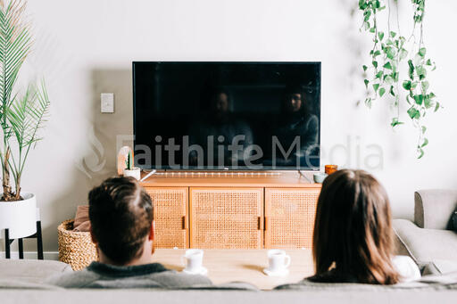 Couple Watching Church at Home on a TV