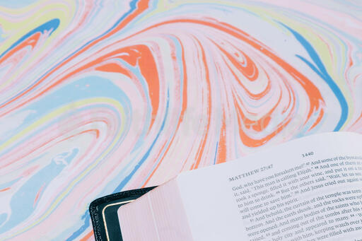Bible Open to Matthew 27 on Pastel Marbled Background