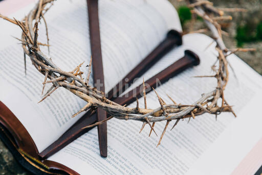 The Crown of Thorns and Crucifixion Nails on an Open Bible