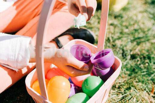 Child Finding a Piece of Candy in Her Easter Egg