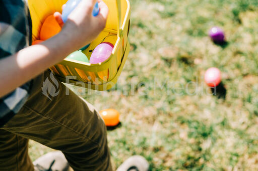 Child Putting an Egg in Their Easter Basket