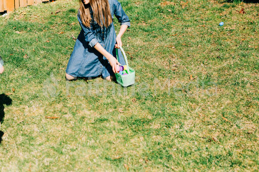 Girl Putting Eggs in Her Easter Basket
