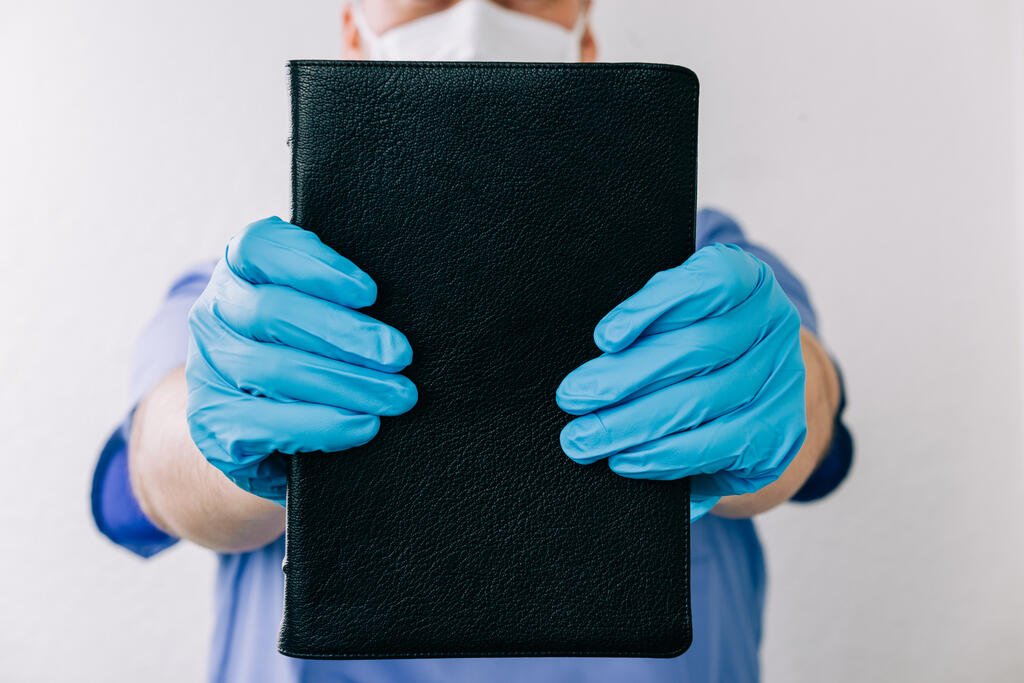 Doctor Holding out a Bible large preview